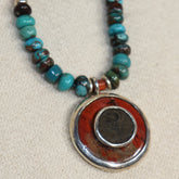 Small Volcanic Round Stone with old Roman Coin